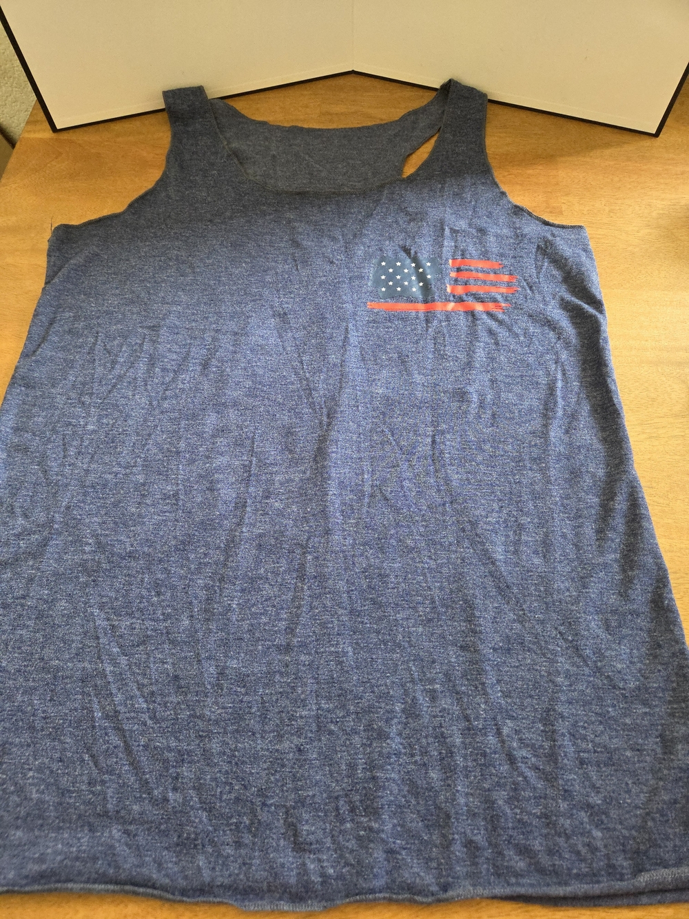 Show your patriotic style with this soft blue “America The Beautiful” sleeveless